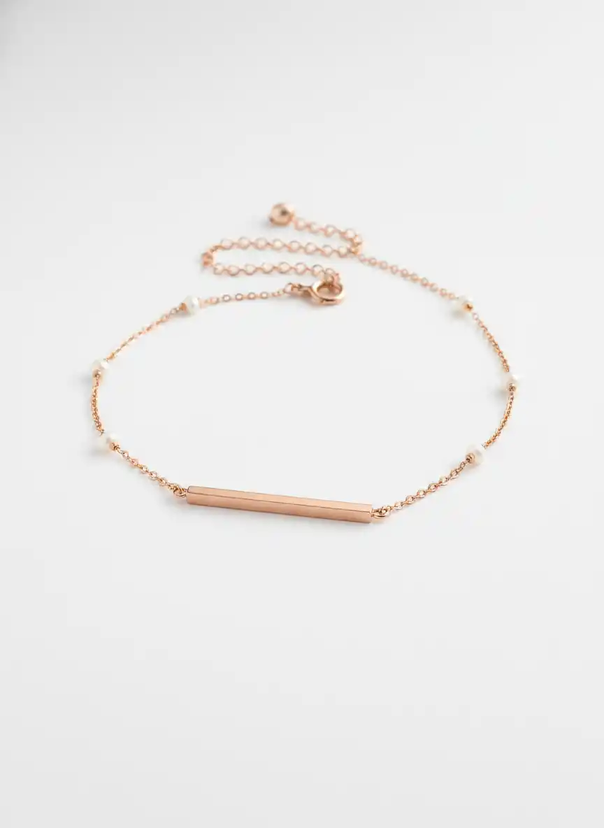 A refined, layered gold chain logo with pearls and a slim bar pendant for timeless luxury branding.