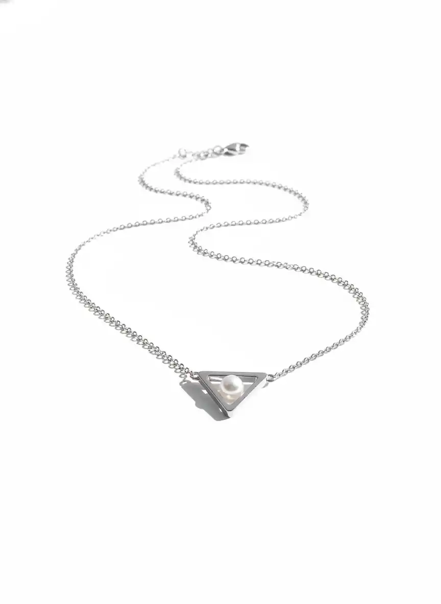 A refined triangular pearl pendant emblem for a modern luxury jewelry brand, radiating minimalist elegance and timeless sophistication.
